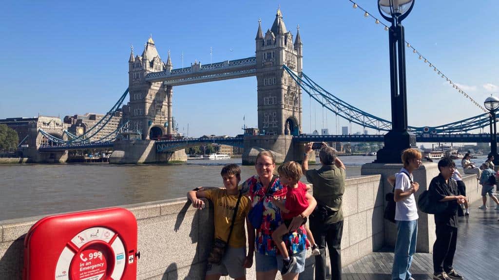 picture of family in front of london bridge in london united kingdom