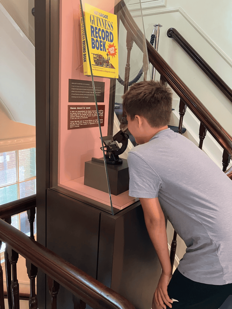 Diamond Museum exhibit with my son looking at a diamond through a microscope